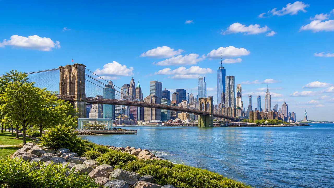 New York City skyline and harbor under a bright sky